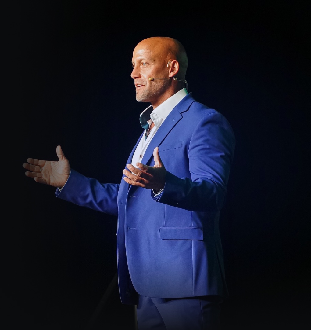 Dr. Adam Boender speaking on stage